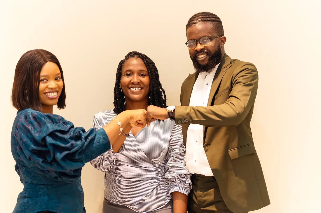 Three happy coworkers collaborating at CWC Consulting